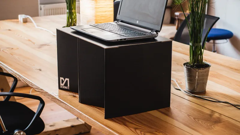 Laptop on a wooden desk in an office workspace, illustrating digital planning.